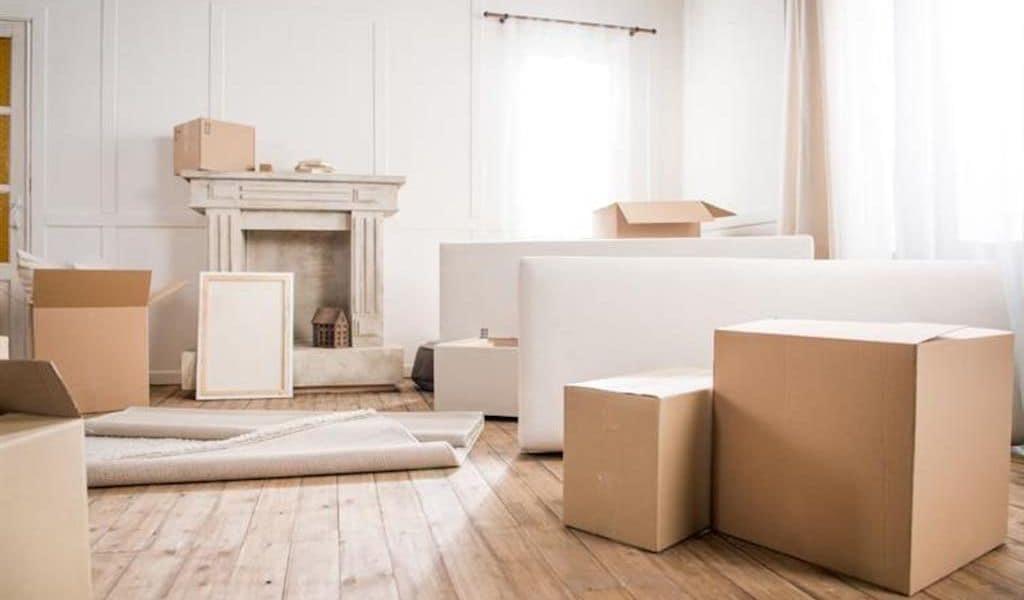 Several cardboard boxes litter the floor of an almost-packed apartment