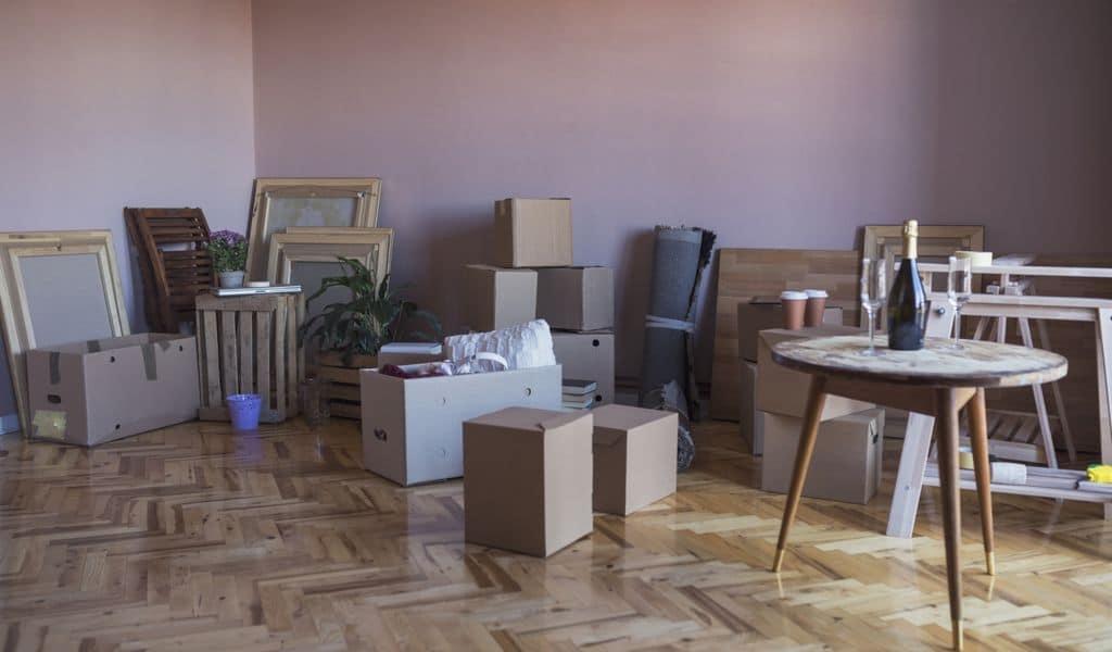 Tables, chairs, boxes and more stacked on a beautiful parquet floor