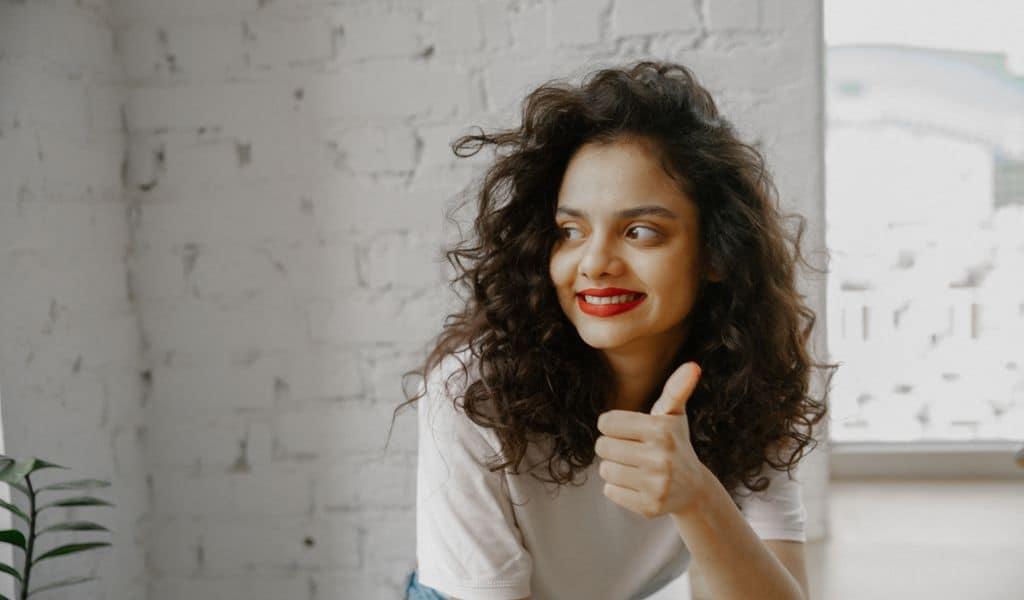 Woman smiling with a thumbs up