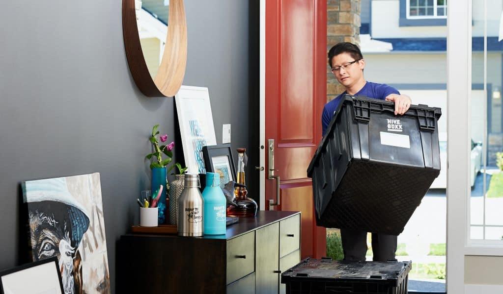 Man carrying plastic moving box