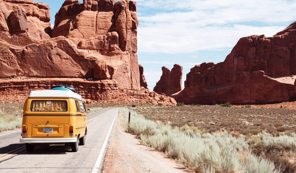 A bus navigates betwixt two mountain ranges