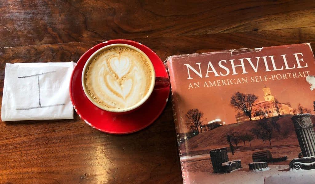 A cappuccino heart helps spell the phrase ‘I love Nashville’ on a hardwood table