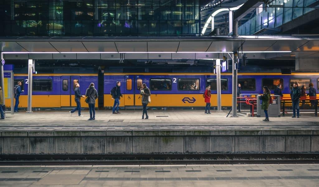 People standing on a platform waiting to board the train