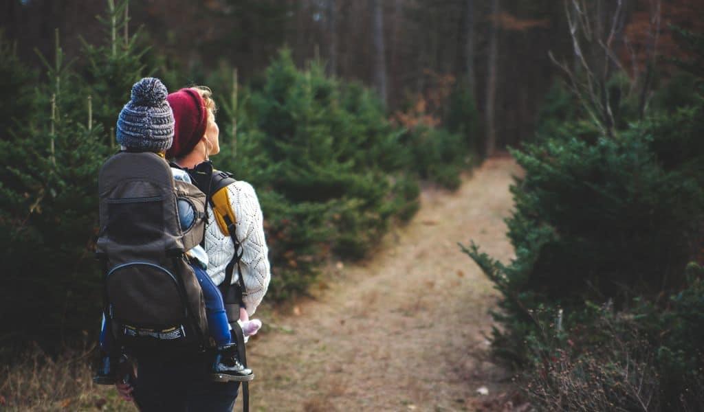 Woman hiking with a child on her back