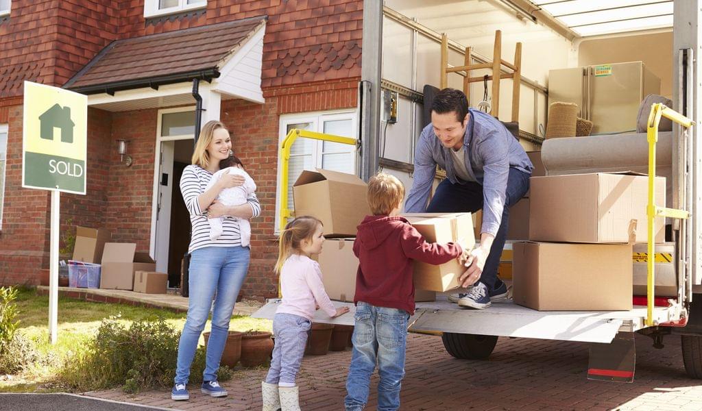 A family moving to Kansas – carrying boxes into a van