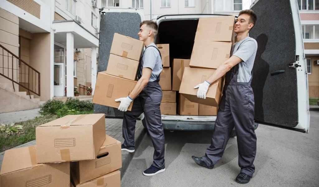 A moving crew unloading packed boxes