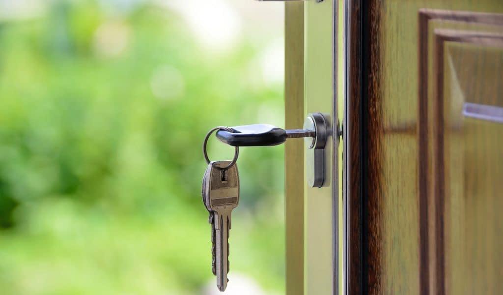 Metal key inside door lock with door pushed slightly ajar