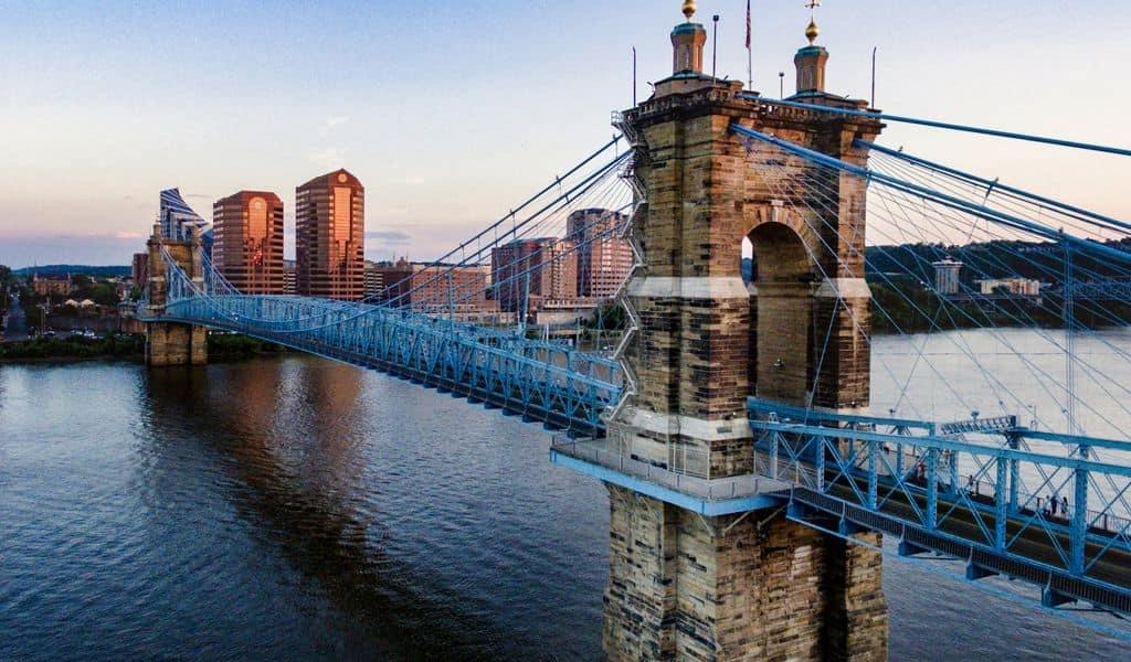 A blue bridge going across a river near Cincinnati, OH