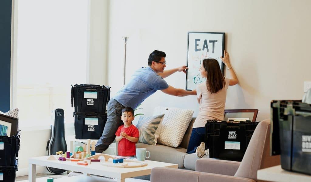 Family hanging artwork in a new home