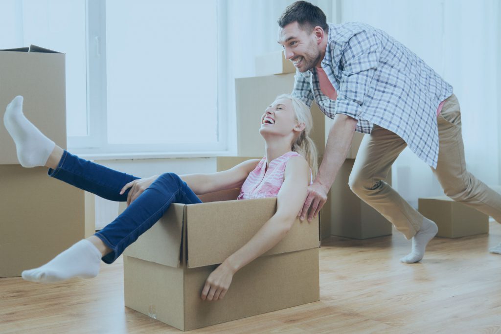 A couple is having fun with moving boxes