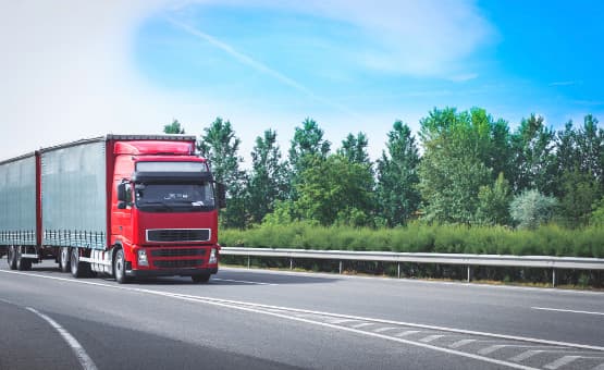 Red moving truck on a highway