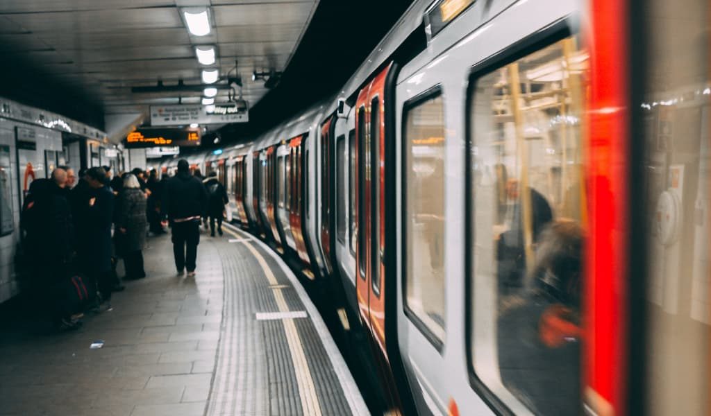 People waiting to board the train in the subway