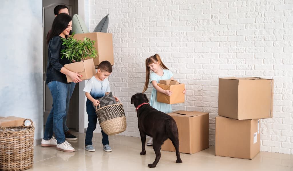 Family packing together with a pet dog