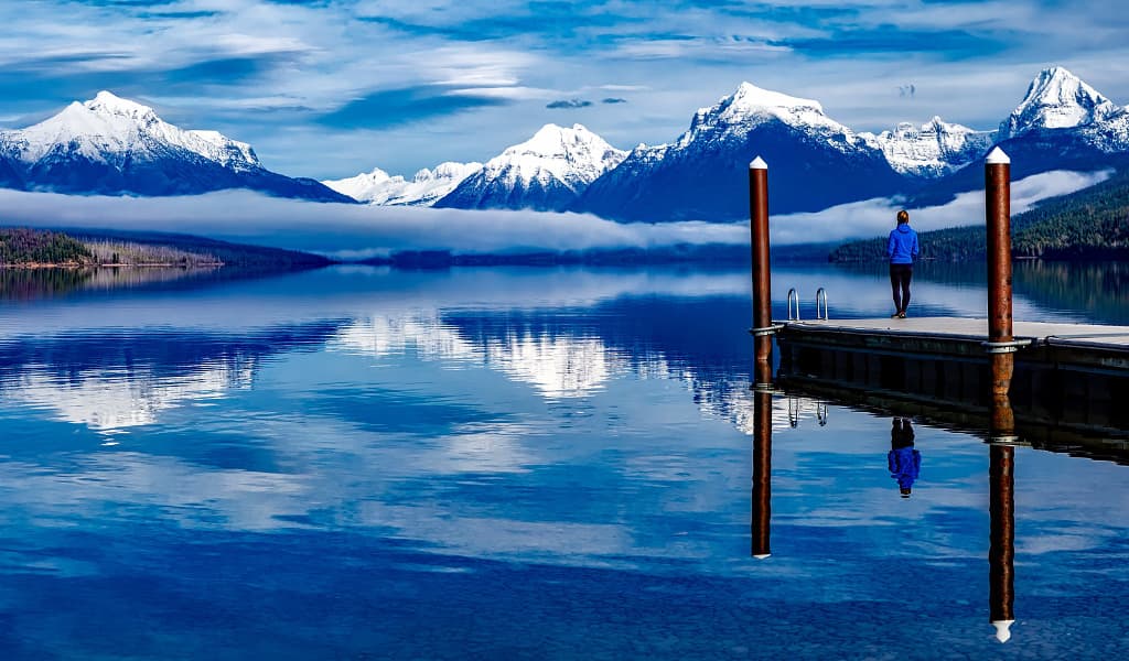 Woman standing on a pier overlooking Lake McDonald