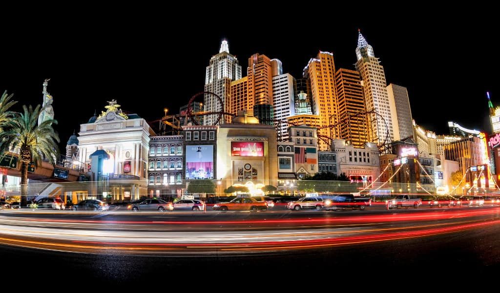 The Las Vegas strip at night showing cars parked in front of skyscrapers and other buildings