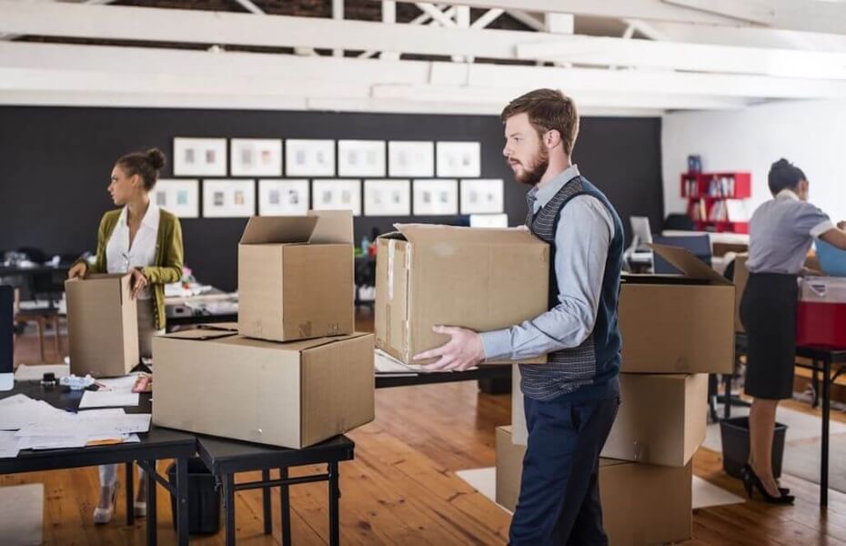 Employees carrying and packing boxes