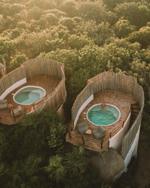 two teal hot tubs with luxurious wooden surroundings, as seen from above