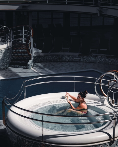 Woman relaxing in a white industrial hot tub