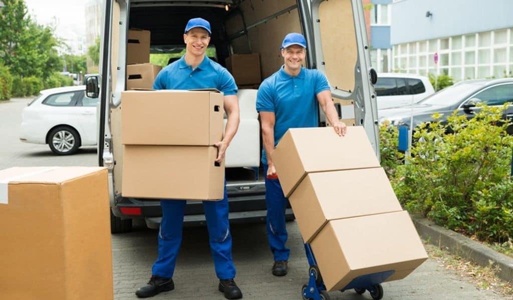 smilling movers holding boxes