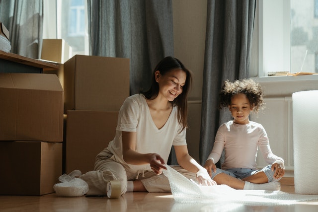 A mother and a daughter wrapping items